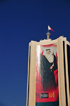 Manama, Bahrain: the King's image at thr National Bank of Bahrain building - Hamad bin Isa Al Khalifa personality cult - Abbey, Hanson, Rowe and Partners architects - photo by M.Torres