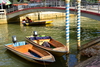 Bandar Seri Begawan, Brunei Darussalam: arch bridge, moored boats and spiral painted pillars - little Venice in Tamu Kianggeh, Subok river - photo by M.Torres