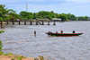 Cameroon, Douala: fishermen and their wooden boat with pier in the background - Mboussa Sengu, near Douala Naval  Base - photo by M.Torres