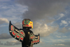 Vancouver, BC, Canada: colorful totem pole against dramatic cloudy sky - carved by native Indian Wade Baker, Skyspirit Studios, North Vancouver - Property released - photo by D.Smith