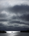 Canada / Kanada - Saskatchewan: fishing boat - reflections of a cloudy sky in this prairie lake just before a storm - photo by M.Duffy