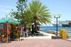 Curacao - Willemstad: Market stall on Governement Plein with Cruise Ship in dockon the Mega Pier in the background. - photo by S.Green