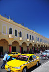 San Salvador, El Salvador, Central America: Parque Libertad - arcade and yellow taxis - 'los portales' - photo by M.Torres