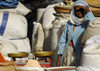 Eritrea - Asmara: a woman waiting for customers at the cereals market - weighing scale - photo by E.Petitalot