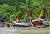 Banjul, The Gambia: wooden fishing boats are built and repaired on the beach, under the coconut trees - photo by M.Torres