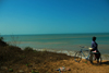 Praia de Varela / Varela beach, Cacheu region, Guinea Bissau / Guin Bissau: man with bike watching the sea / homem a observar o mar - photo by R.V.Lopes