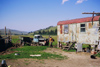 Kazakhstan - Almaty oblys: a farmer with his old tractor and a sheet metal house - photo by E.Petitalot