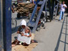 Serbia - Kosovo - Pec / Peja: 'Try the joys of life' - beggar with sign and baby - photo by J.Kaman