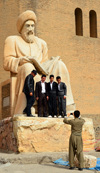 Erbil / Hewler / Arbil / Irbil, Kurdistan, Iraq: Kurdish men have their picture taken with the statue of the historian Ibn Al-Mustawfi aka Mubarak Ben Ahmed Sharaf-Aldin at the entrance to Arbil Citadel - Qelay Hewlr - UNESCO world heritage site - photo by M.Torres