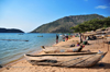 Cape Maclear / Chembe, Malawi: hand carved pirogues an tables of drying Usipa fish / lake sardines on the beach and the cape - David Livingstone named the cape after the astronomer Thomas Maclear - Domwe Island on the left - photo by M.Torres