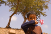 Small Sahara, Morocco: Berber boy trying to sell flowers - photo by Sandia