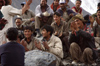 Pakistan - Karakoram mountains - Himalayan range - Northern Areas: Balti porters sing and relax - photo by A.Summers