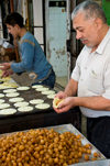 Hebron, West Bank, Palestine: local food vendor preparing sweets - photo by J.Pemberton