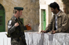 Hebron, West Bank, Palestine: Israeli soldier checking Palestinian ID at checkpoint - photo by J.Pemberton