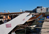 Doha, Qatar: dhow prows with State of Qatar registration - Dhow harbour - south end of the Corniche in the background, Regency Business Center - photo by M.Torres