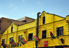 Johannesburg, Gauteng, South Africa: Bree St - yellow faades of historical wharehouses with SADC countries flags - photo by M.Torres