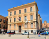 Cagliari, Sardinia / Sardegna / Sardigna: school of Santa Caterina, desined by the engineer Tito Ciardi - takes its name from the Dominican convent demolished in the early 20th century - three floors resting on a stone plinth, openings are inspired by the classical language with gables and lintels, the is cornice surmounted by ornamental vases - Terrazza Umberto I - cathedral dome in the background - quartiere Castello - photo by M.Torres