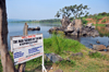 Jinja, Uganda: source of the Nile river at Lake Victoria, Napoleon gulf - sign at Ripon Falls island, the falls themselves disappeared with the construction of Owen Falls Dam - photo by M.Torres