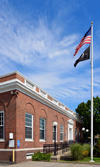 Mystic, CT, USA: red brick building of the US Post Office on East Main street - US and Mia POW flags - New London County - photo by M.Torres