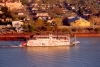 New Orleans (Louisiana): S.S. Natchez paddlewheel steamship on the Mississippi river, passing by Mardi Gras World - photo by M.Torres