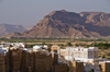 Shibam, Hadhramaut Governorate, Yemen: buildings of the Old Walled City of Shibam with views to the mountains beyond - UNESCO World Heritage Site - the Manhattan of the desert - the tallest mud buildings in the world  - photo by J.Pemberton