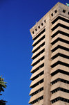 Lusaka, Zambia: Society House, a skyscraper built in the 1970s with copper money, was gutted by a fire in the 1990s - a 20-storey extruded concrete concertina with a neo-oriental brutalist pagoda on top - will become a Holiday Inn - Cairo Road - Central Business District - photo by M.Torres